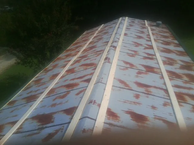 Rusted metal roof panels with new wood purlins before replacement — Storm Damage Roof Repair in Appomattox by Roofing Brothers